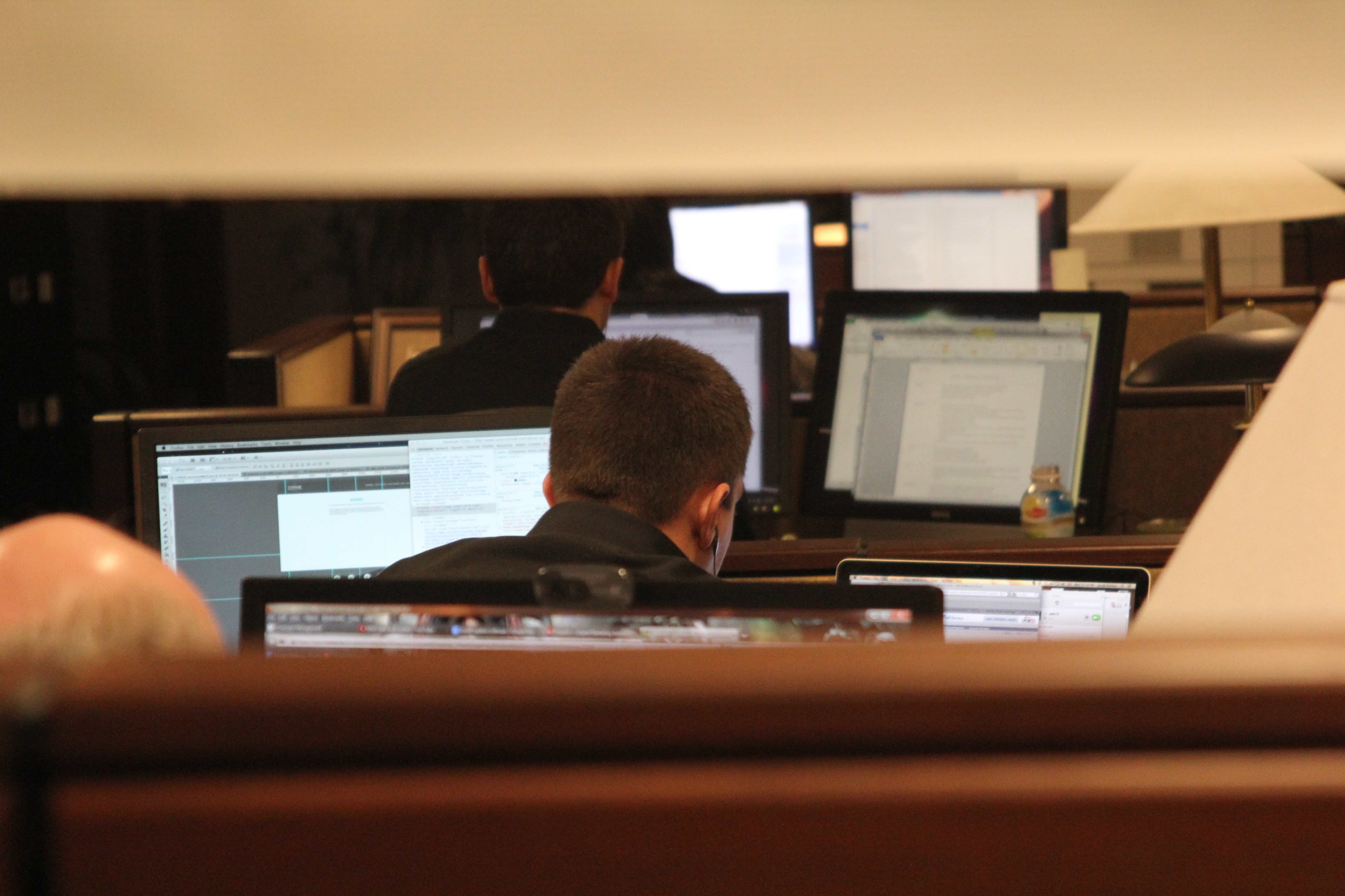 man is working in a computer, face is not visible